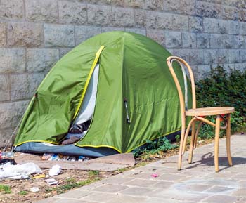 Green tent next to sidewalk