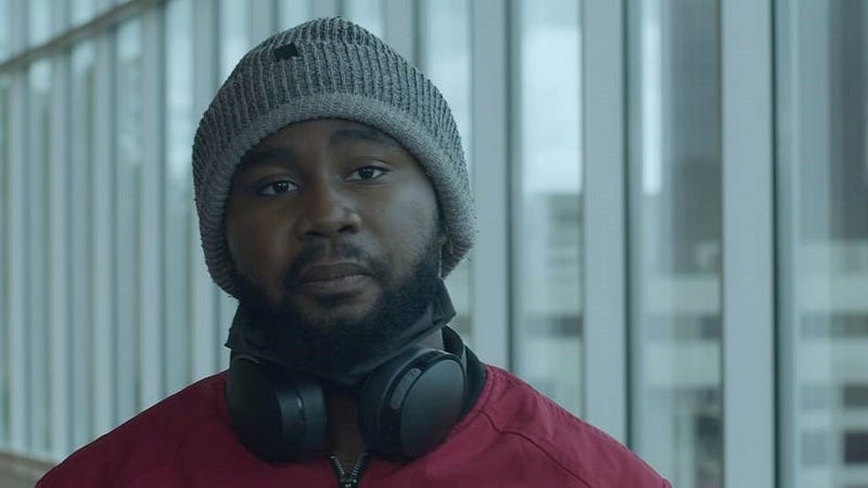 Photo of youth Black man with a full beard and wearing a gray hat.